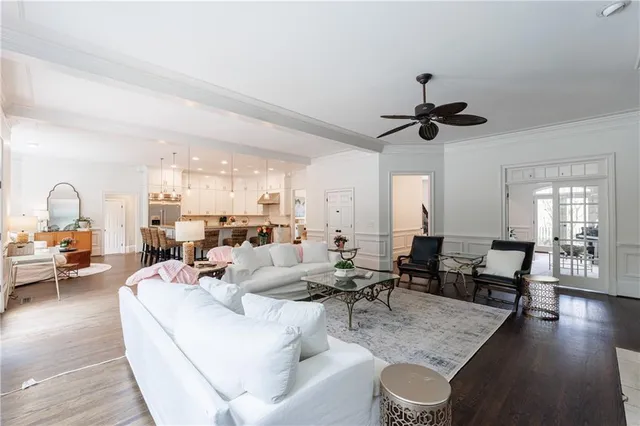 a kitchen with granite countertop a stove a sink and white cabinets