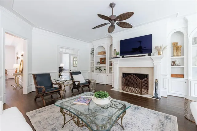 a kitchen with stainless steel appliances granite countertop a sink a stove and white cabinets with wooden floor