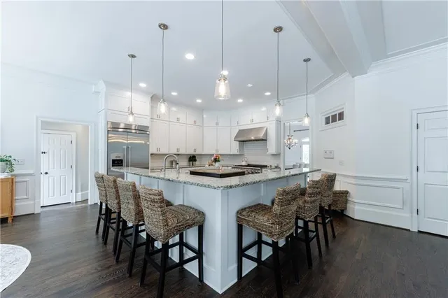 a bathroom with a granite countertop toilet sink and mirror