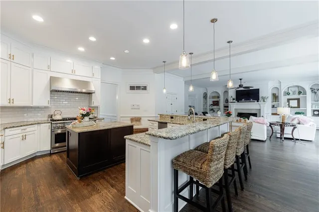 a spacious bedroom with a large bed and a chandelier