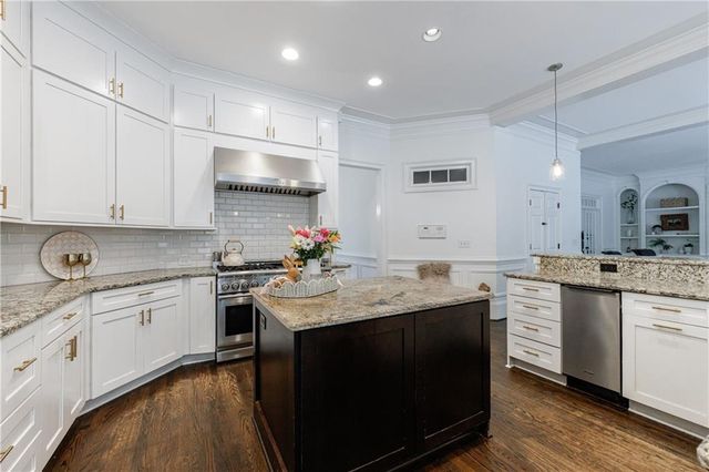 a living room with furniture a fireplace and a table