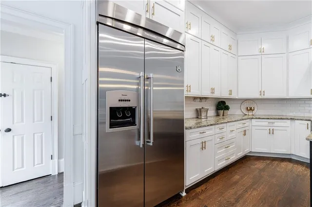 a spacious bathroom with a granite countertop sink mirror and a