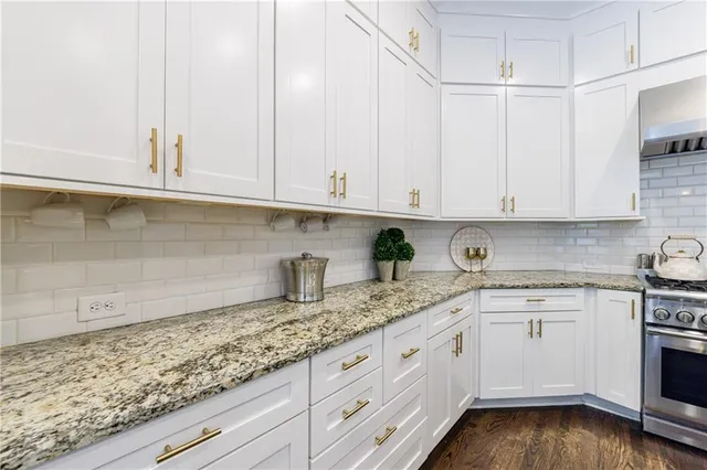 a bathroom with a granite countertop sink a mirror and a shower