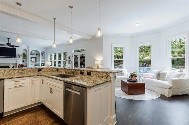 a white bath tub sitting in a bathroom next to a window