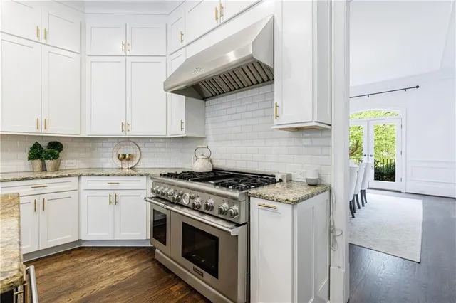 a spacious bathroom with a double vanity sink a mirror and a bathtub