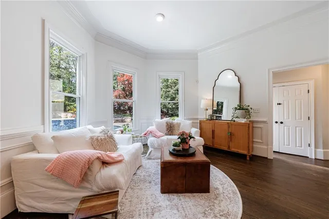 a bathroom with a granite countertop toilet a sink a mirror and a shower