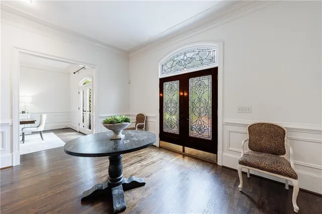 a living room with furniture a piano and a potted plant