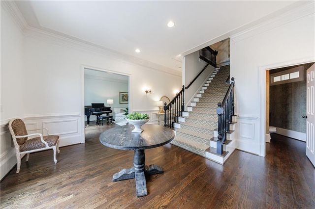 a living room with furniture fireplace and a large window