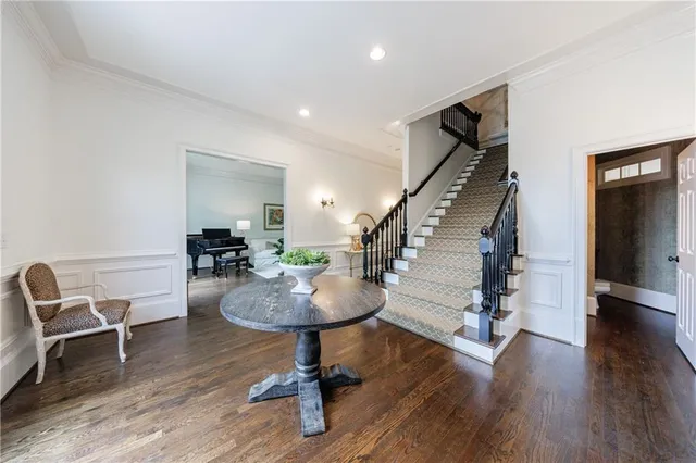 a living room with furniture fireplace and a large window