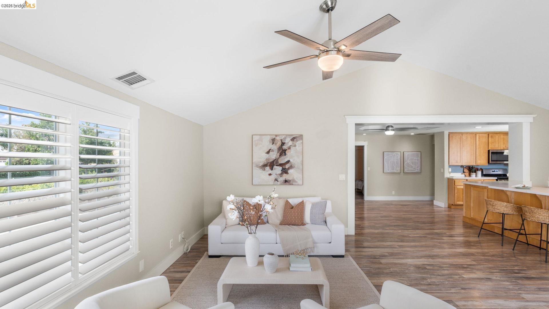 700 Brownstone Road Oakley, CA 94561 - Photo 19 of 58 Vaulted ceilings enhance this living area featuring wood-finish flooring, plantation shutters, and a contemporary ceiling fan