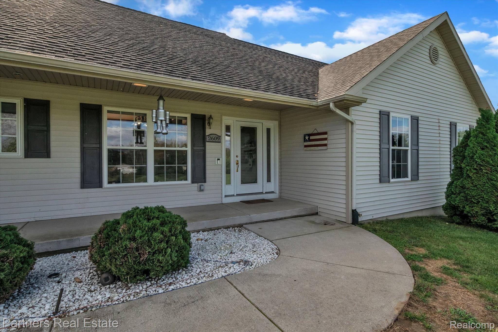 2609 Murray Road Stockbridge, MI 49285 - Photo 38 of 58 The covered front porch is the perfect spot to enjoy a cup of coffee and look over your land!