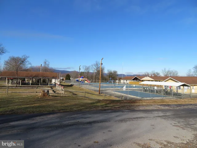 a view of grassy field with houses