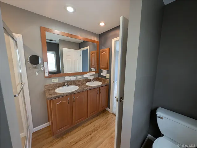 a bathroom with a sink mirror vanity and toilet