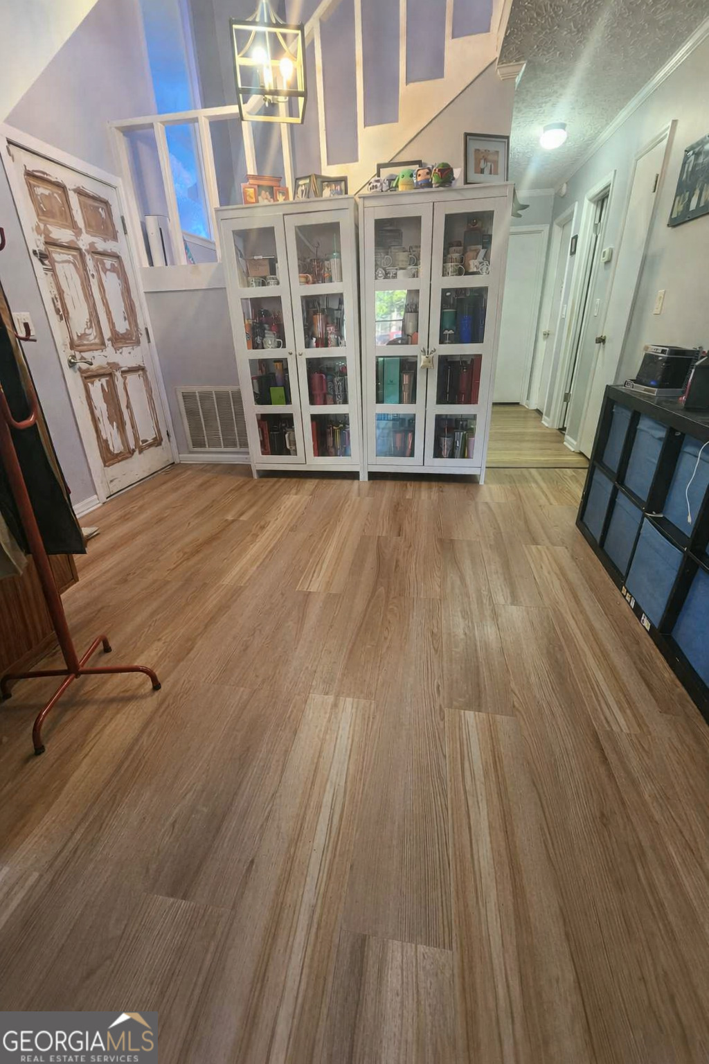 167 1st Avenue Cochran, GA 31014 - Photo 8 of 19 an empty room with wooden floor and windows