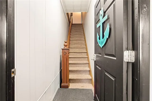a kitchen with white cabinets and window