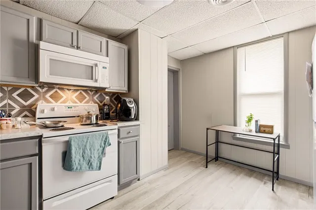 a kitchen with sink refrigerator and furniture