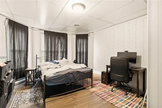 a bedroom with a bed dresser and a window