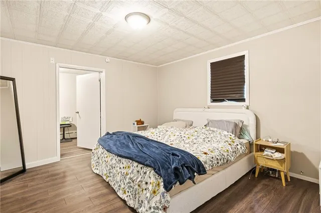 a bedroom with a bed and a large mirror