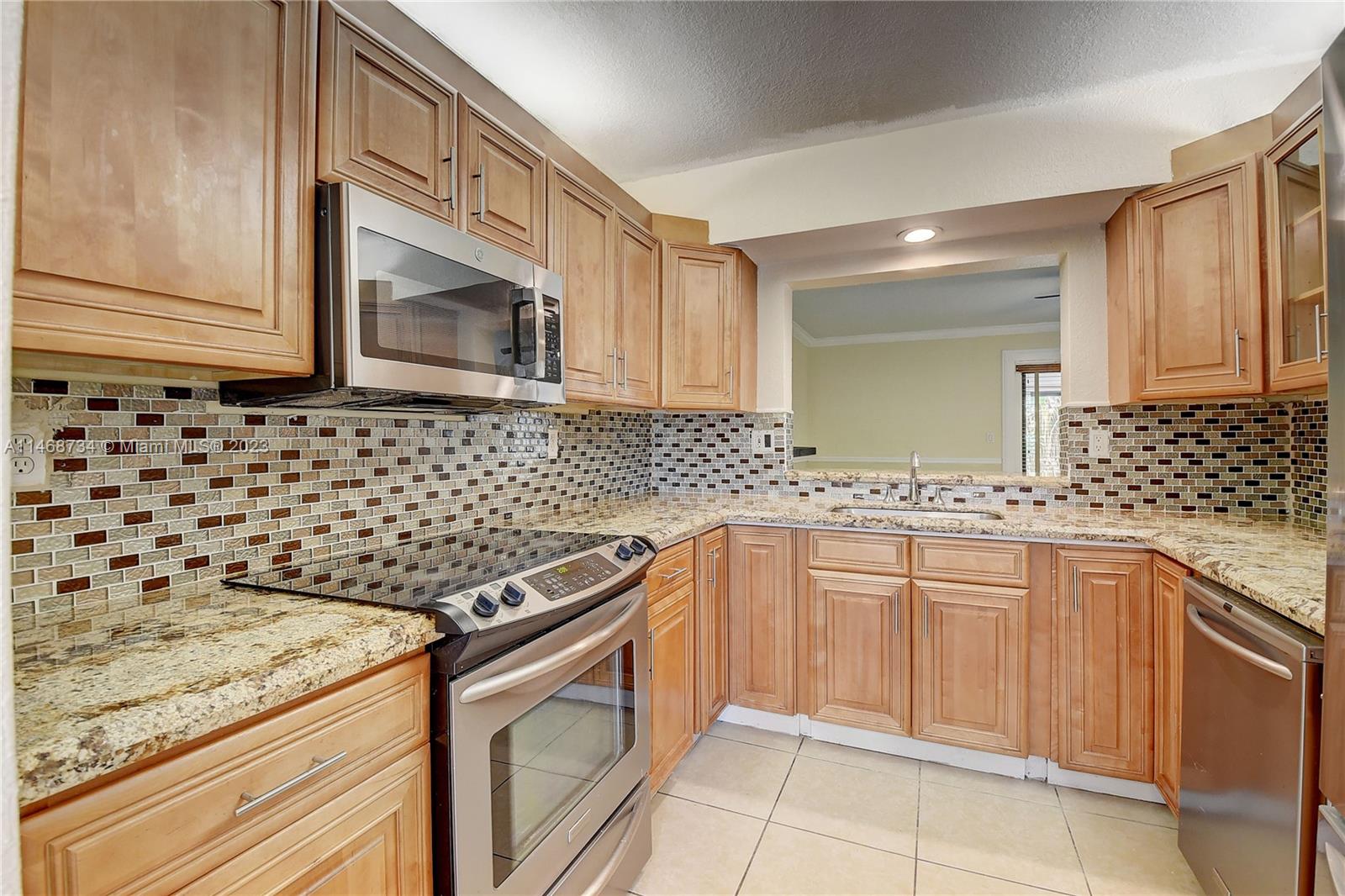 Sandalfoot Cove Boca Raton, FL 33428 - Photo 15 of 44 a kitchen with granite countertop a sink stove and cabinets