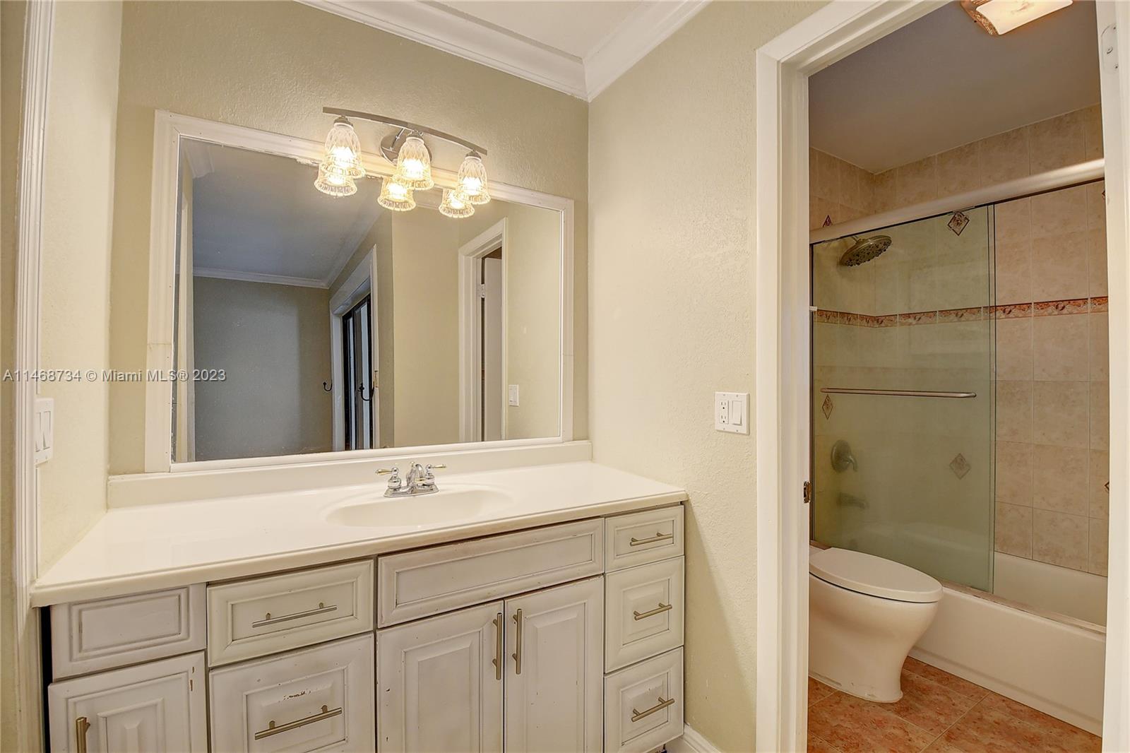 Sandalfoot Cove Boca Raton, FL 33428 - Photo 25 of 44 a bathroom with a sink a toilet and shower