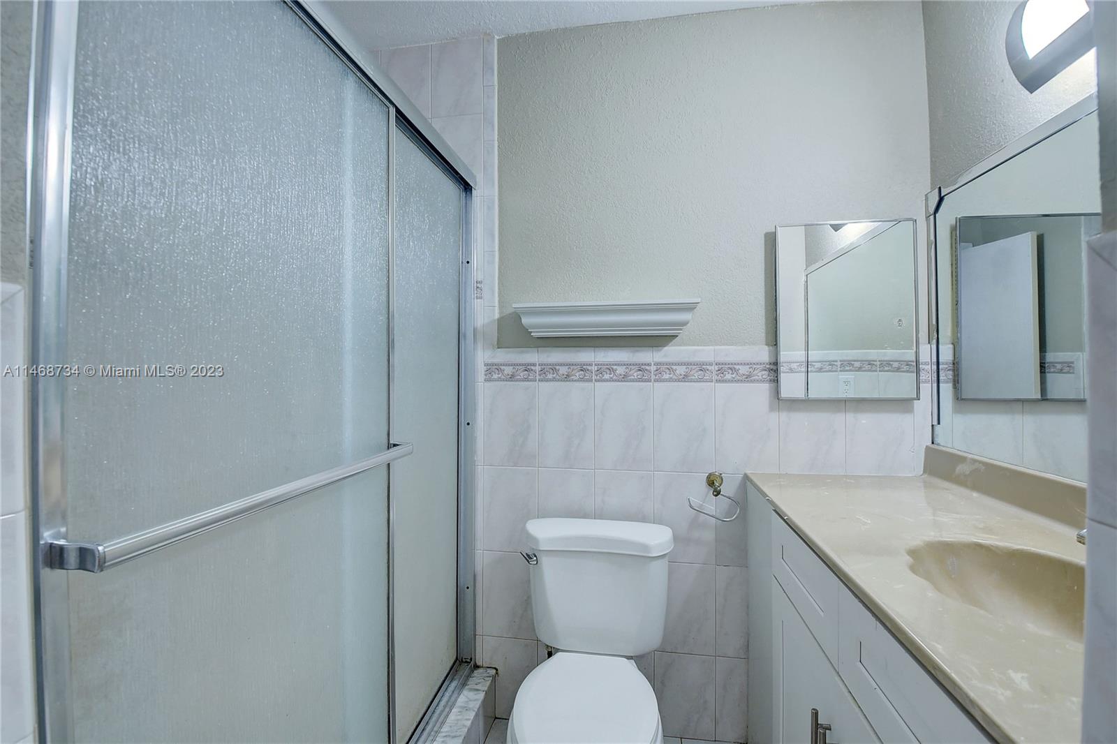 Sandalfoot Cove Boca Raton, FL 33428 - Photo 26 of 44 a bathroom with a granite countertop sink toilet and shower