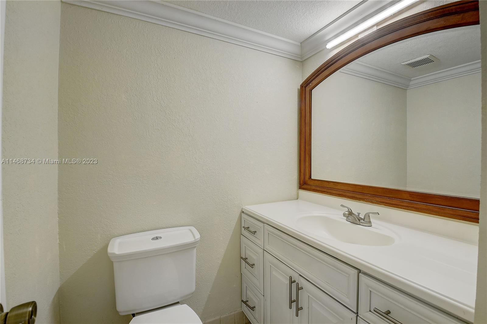 Sandalfoot Cove Boca Raton, FL 33428 - Photo 5 of 44 a bathroom with a toilet sink and mirror