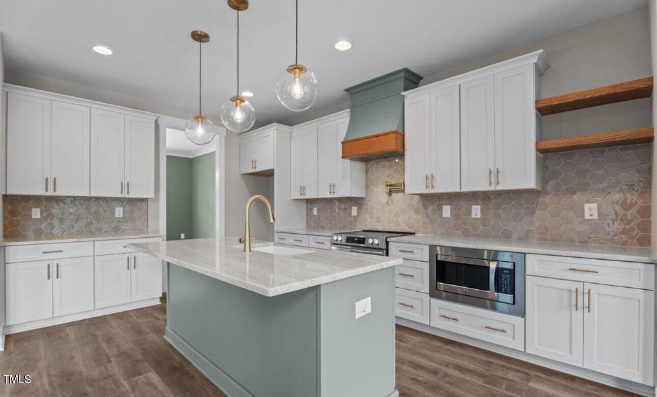 8 North Big Woods Road Spring Hope, NC 27882 - Photo 4 of 5 a kitchen with stainless steel appliances granite countertop a sink a stove and a refrigerator