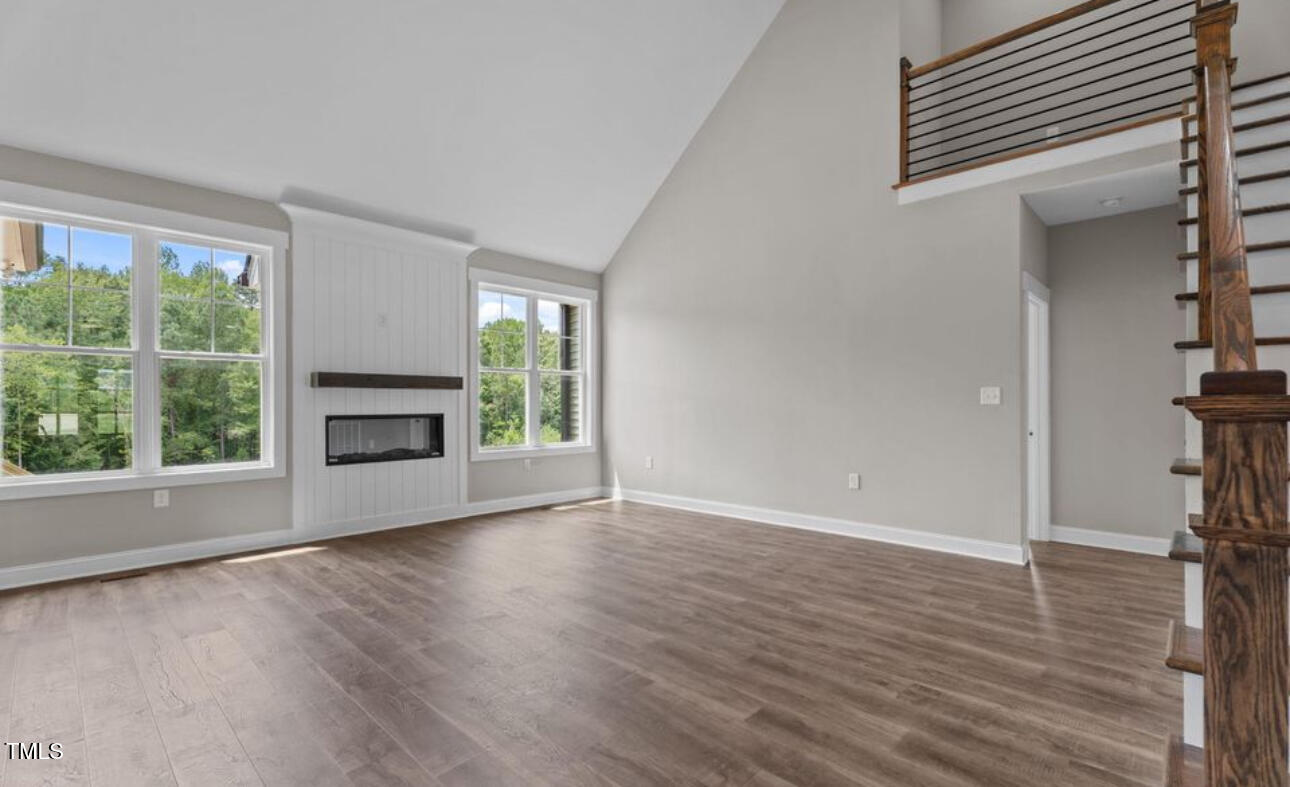 8 North Big Woods Road Spring Hope, NC 27882 - Photo 5 of 5 wooden floor fireplace and windows in an empty room