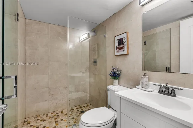 a bathroom with a sink toilet and shower