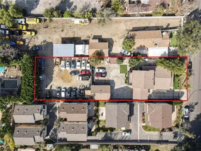 an aerial view of multiple houses with yard