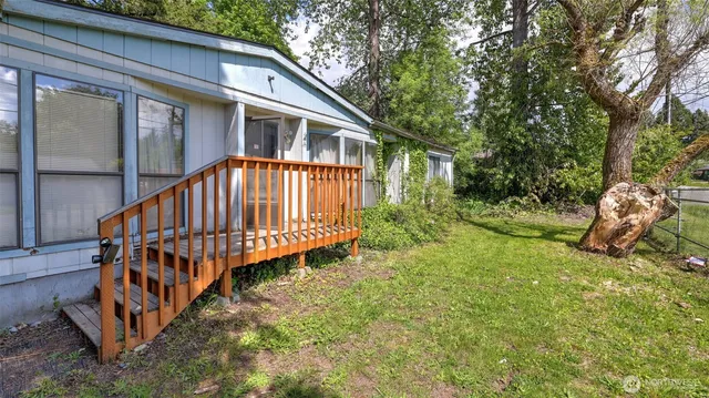 a view of a house with backyard and sitting area