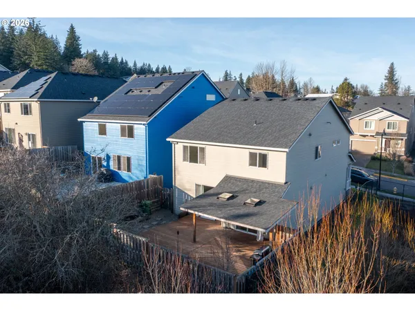 a aerial view of a house with a yard and balcony