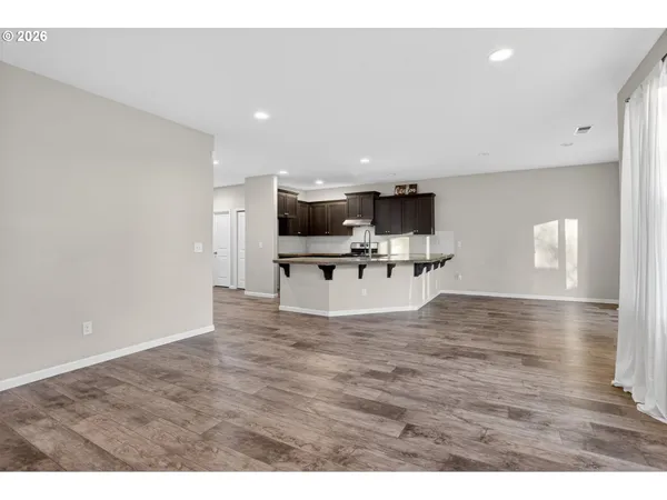 a view of kitchen with sink microwave and furniture