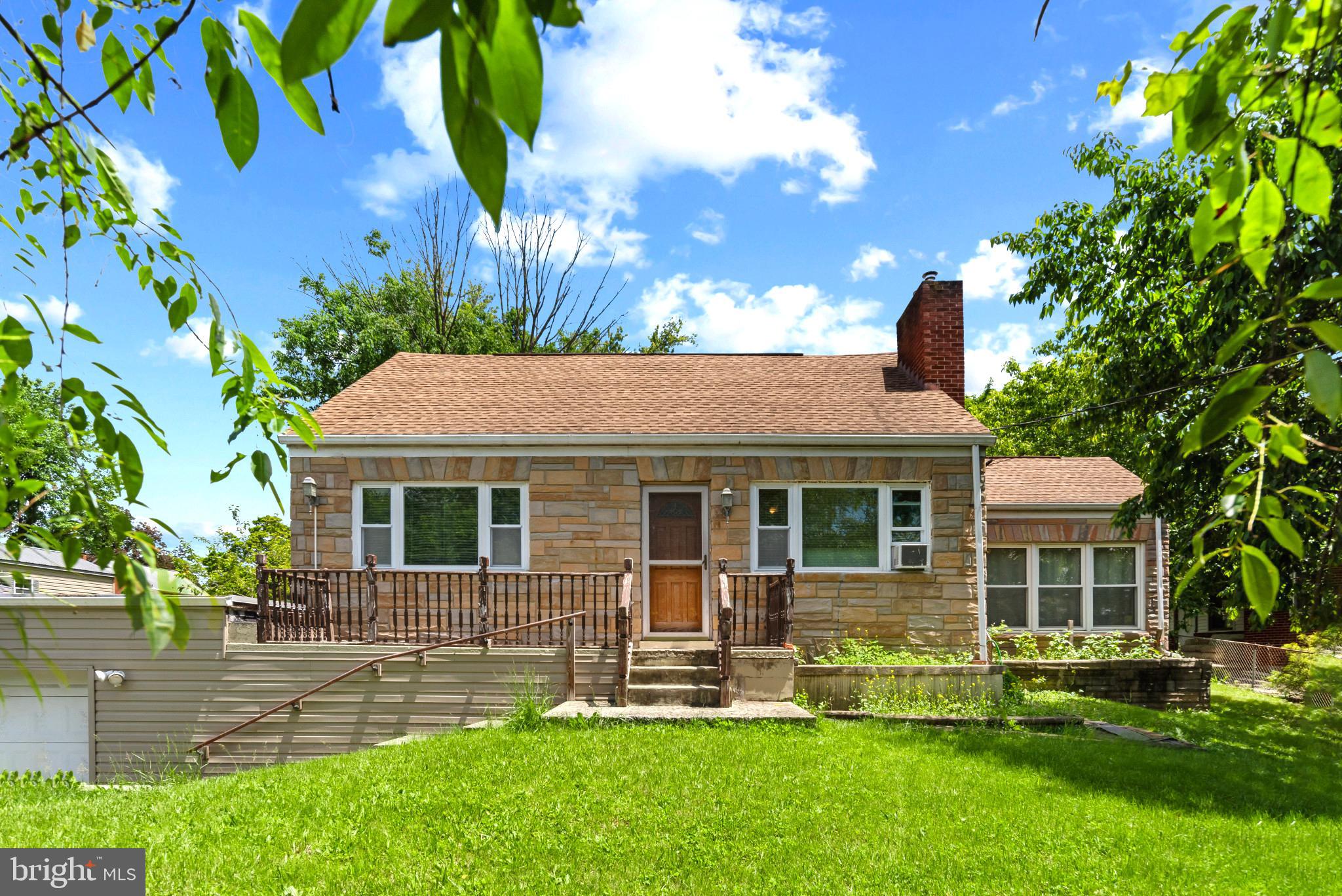 a front view of a house with a yard table and chairs
