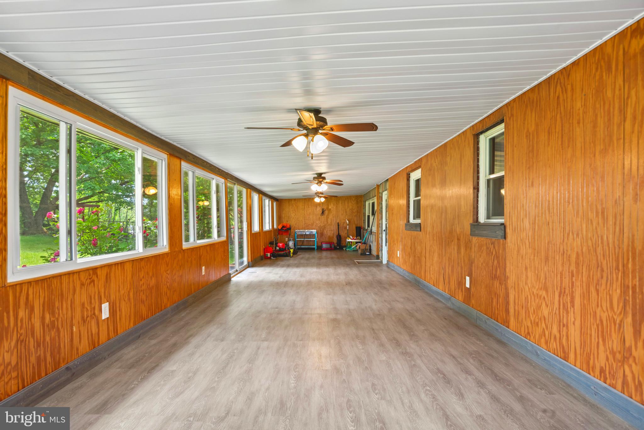 201 Village Road Harrisburg, PA 17112 - Photo 14 of 32 a view of a porch with wooden floor and chandelier