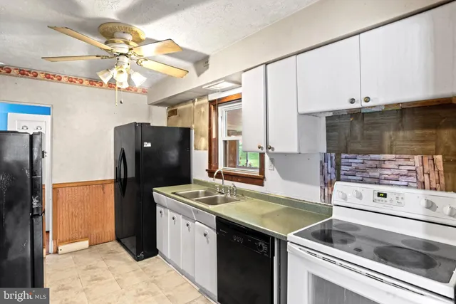 a kitchen with a refrigerator and a stove