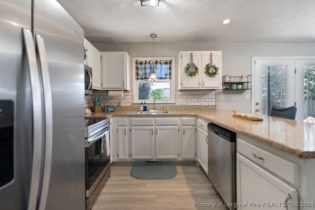 1025 Rim Road Fayetteville, NC 28314 - Photo 6 of 16 a kitchen with stainless steel appliances granite countertop a refrigerator sink and stove