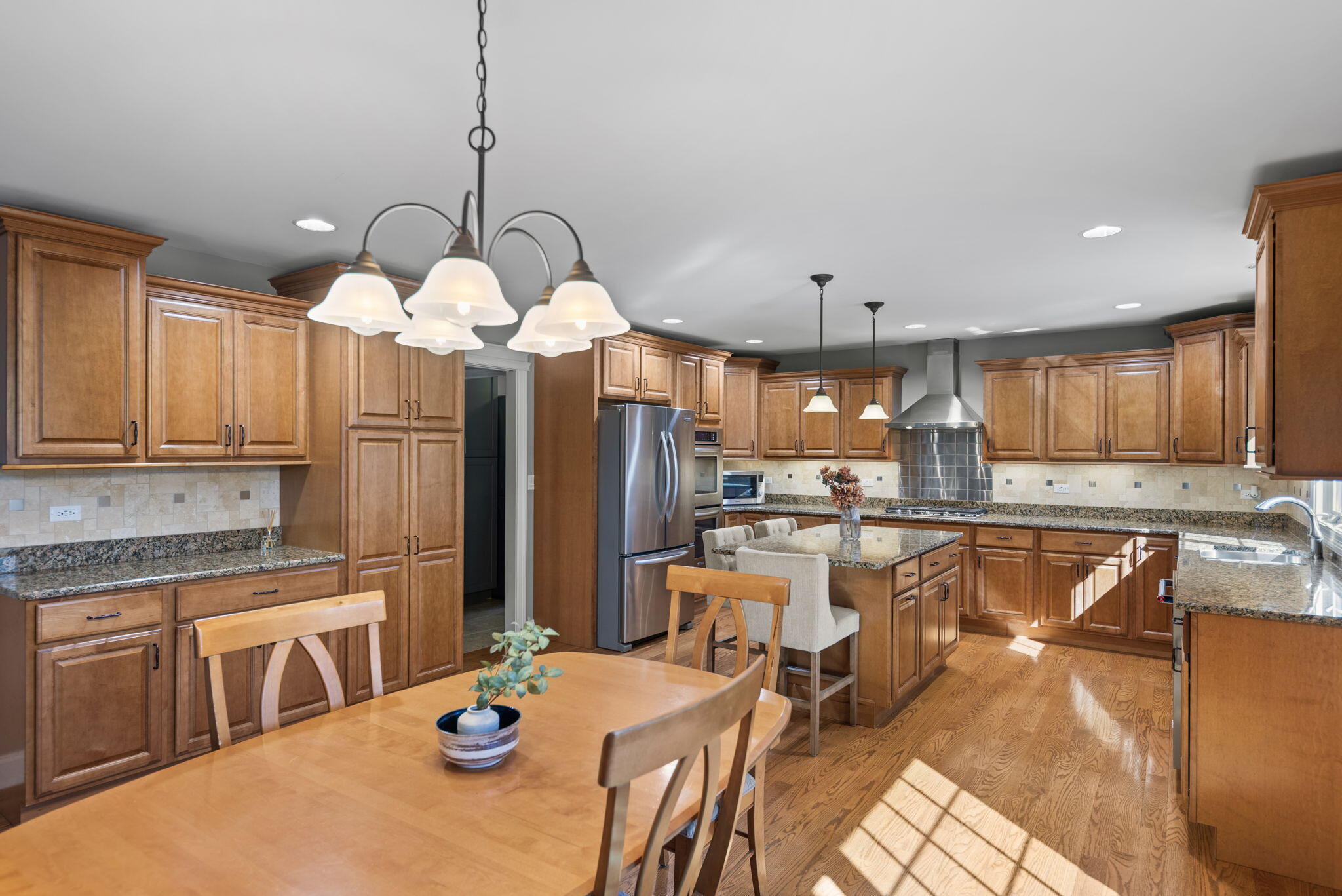 10135 S Branch St. John, IN 46373 - Photo 13 of 45 a large kitchen with a table and chairs