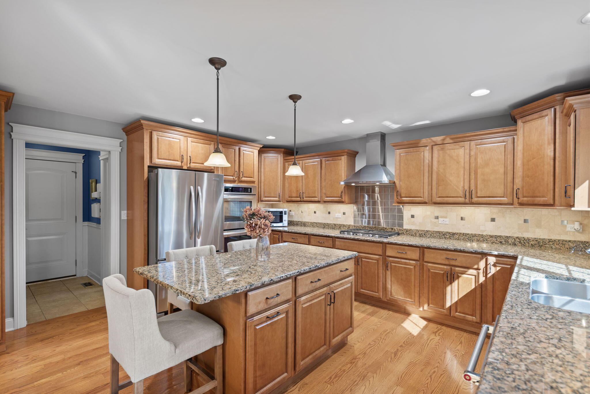 10135 S Branch St. John, IN 46373 - Photo 17 of 45 a kitchen with granite countertop sink refrigerator dining table and chairs