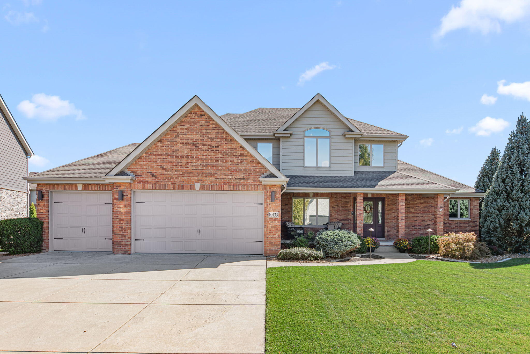 10135 S Branch St. John, IN 46373 - Photo 2 of 45 a front view of a house with garden