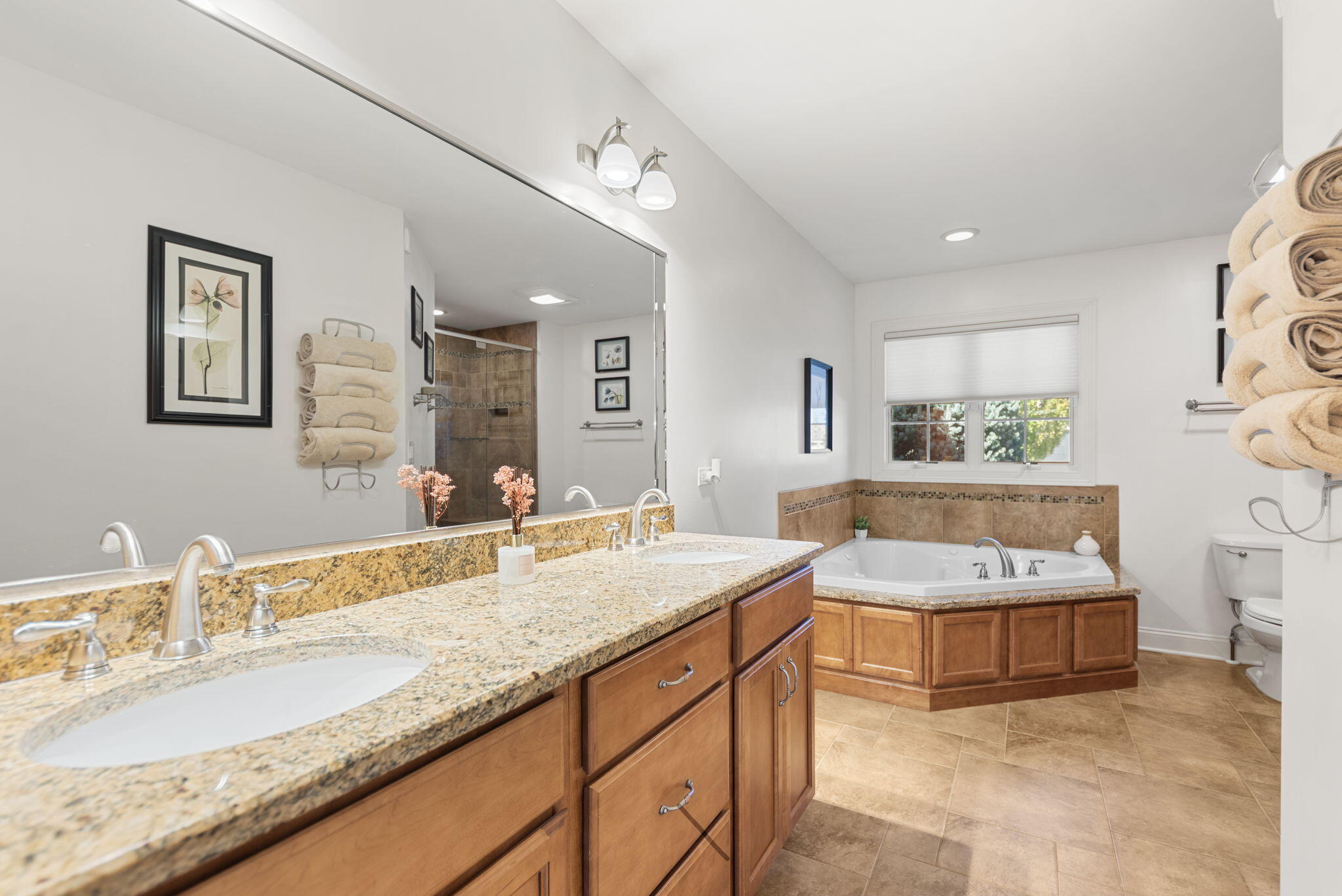 10135 S Branch St. John, IN 46373 - Photo 21 of 45 a spacious bathroom with a granite countertop tub a double vanity sink and a large mirror