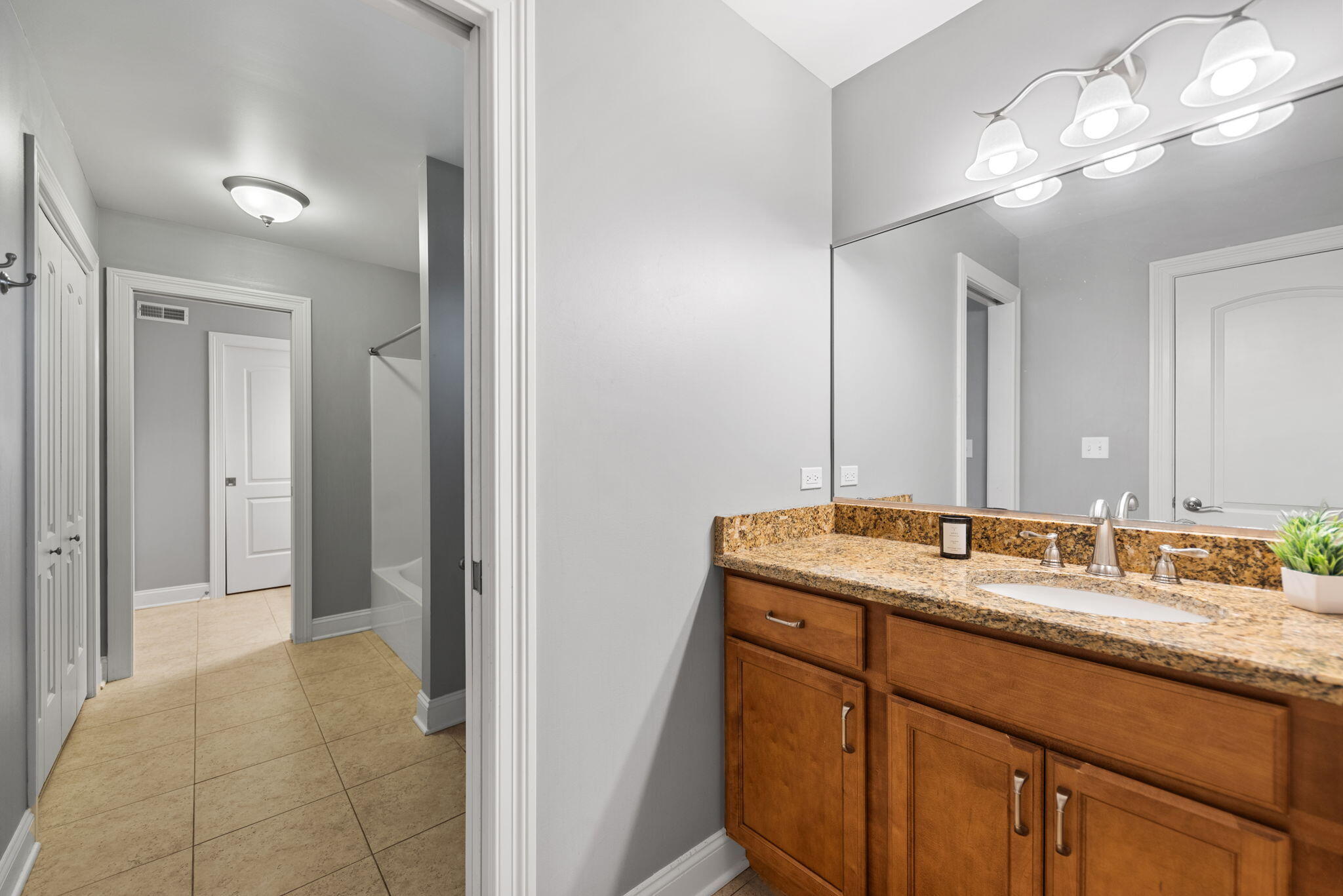 10135 S Branch St. John, IN 46373 - Photo 26 of 45 a bathroom with a granite countertop double vanity sink a mirror and shower