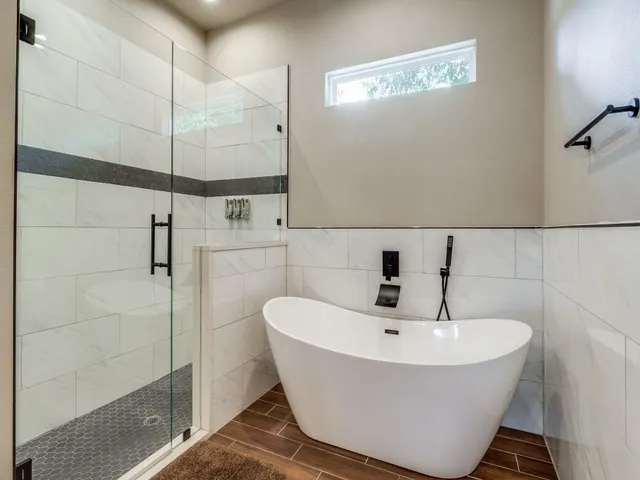 a bathroom with a bathtub and shower