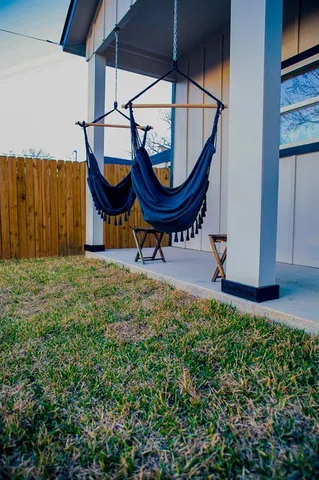 a view of a backyard with table and chairs