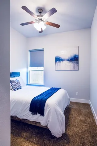 a bedroom with a bed and a painting on the wall