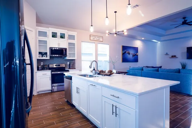a kitchen with stainless steel appliances a sink stove and refrigerator