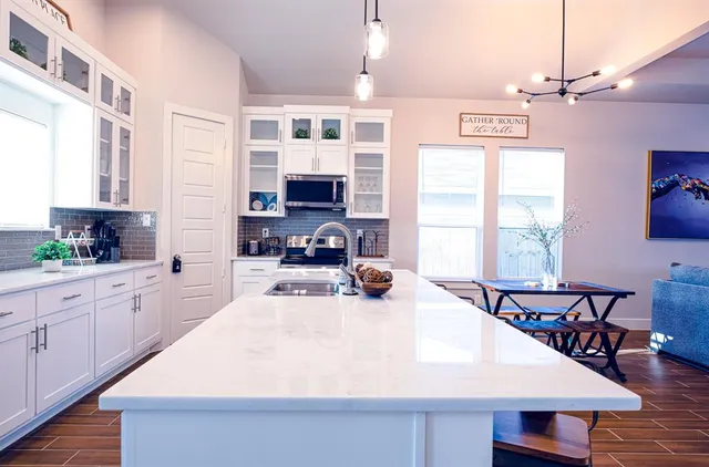 a large white kitchen with a large window