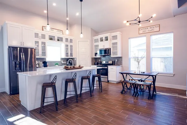 a large kitchen with a table and chairs