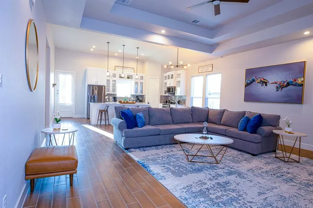 a living room with furniture and wooden floor