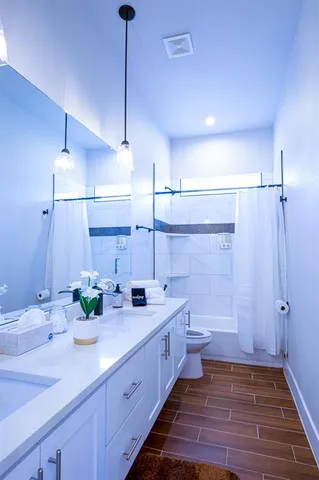 a spacious bathroom with a double vanity sink a mirror and a shower